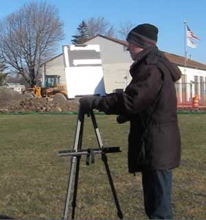 Setting up an easel outdoors.